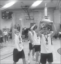  ?? Herald photo by Dale Woodard ?? LCI Rams senior Justin Pitcher hoists the Southern Alberta High School Volleyball League regular season trophy aloft while teammate and fellow senior Cale Vanderzee celebrates following a 3-0 win over the Catholic Central Cougars Monday night at LCI.