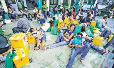  ??  ?? BONE TIRED – Poll watchers sleep on the pavement of this basketball court while guarding ballot boxes at the Salawag Elementary School in Dasmariñas, Cavite, after tension rose due to contested votes in the Barangay and Sanggunian­g Kabataan elections,...