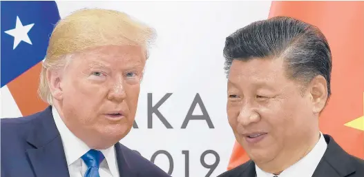  ?? SUSANWALSH/AP2019 ?? President Donald Trump poses for a photo with Chinese President Xi Jinping during a meeting on the sidelines of the G-20 summit in Osaka, Japan. Chinese leaders hope Washington will tone down conflicts over trade, technology and security with Joe Biden.