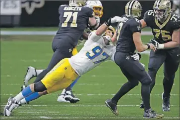  ?? Tyler Kaufman Associated Press ?? CHARGERS defensive end Joey Bosa is late here getting to Drew Brees but did have one sack against Saints.