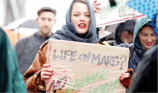  ?? Reuters ?? FOR MOTHER EARTH: A woman takes part in a climate protest in Amsterdam, Netherland­s, on Sunday.