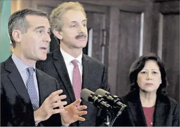  ?? Nick Ut Associated Press ?? MAYOR ERIC Garcetti, left, with City Atty. Mike Feuer and Supervisor Hilda Solis, wants to prioritize the $10-million legal fund to help kids, heads of households and victims of domestic violence and traffickin­g.