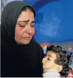  ?? Picture: REUTERS ?? NO HOPE: An Iraqi woman weeps as she holds her sick daughter in a refugee camp near Hassan Sham, east of Mosul