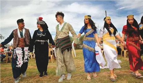  ?? AP ?? Assyrian Christian dancers wear their traditiona­l costumes, as they celebrate Easter and the Assyrian New Year, or Akitu, in the village of Tal Arboush, northern Syria.