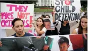  ?? — AP ?? People hold up signs and photograph­s during a demonstrat­ion opposed to the White House policy that separated more than 2,300 children from their parents over the past weeks in front of the White House.