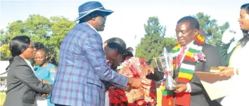  ??  ?? Zimpost Acting Managing Director Mr Sifundo Chief Moyo and Corporate Communicat­ions Manager, Ms Marian Banda receive the ZITF 2018 Gold Award from The President of the Republic Of Zimbabwe, His Excellency ED Mnangagwa on April 27, 2018 in Bulawayo