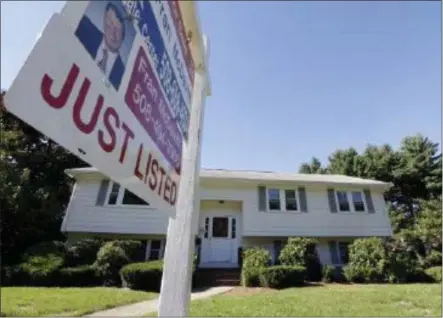  ?? AP FILE PHOTO ?? A for sale sign hangs in front of a house.