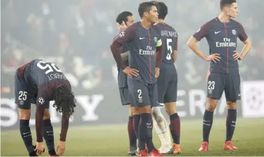  ??  ?? DOWN AND OUT: PSG players react to being knocked out of the Champions League by Real Madrid at the Parc des Princes on Tuesday.