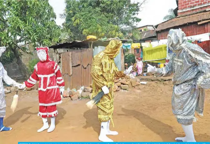  ??  ?? FREETOWN: The Kofi Jalloy secret society portraying four devils dancing during a Araba dance performanc­e in Freetown. The devils seen are from left to right Baykey (white), Faerie (red), Gargoda (yellow) and Labalaba (gray). — AFP