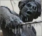  ?? JAY JANNER — AUSTIN AMERICAN-STATESMAN VIA AP ?? Icicles hang from the Angelina Eberly statue during a winter storm in downtown Austin, Texas, on Wednesday.
