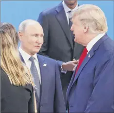  ?? Pablo Martinez Monsivais / Associated Press ?? In this Nov. 30 photo, Trump, right, walks past Russia’s President Vladimir Putin, left, at the start of the G20 summit in Buenos Aires, Argentina.