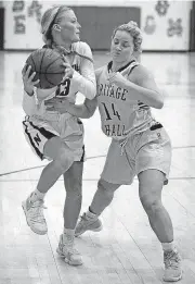  ?? SARAH PHIPPS, THE OKLAHOMAN] [PHOTO BY ?? Newcastle’s Morgan Bergt looks to pass the ball as Heritage Hall’s Hannah Stanley defends during the girls high school basketball game between Heritage Hall and Newcastle at Newcastle High School on Thursday.