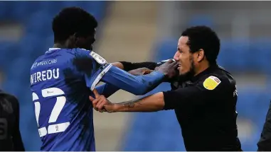  ??  ?? FIESTY: Brendan Sarpong-wiredu of Colchester United clashes with Cristian Montano of Port Vale.