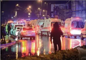  ?? The Associated Press ?? Medics and security officials work at the scene after an attack at a popular nightclub in Istanbul, early on Sunday. An armed man has opened fire at a nightclub in Istanbul during New Year's celebratio­ns, killing 39 people before fleeing.