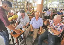  ?? — AFP photos ?? Iraqis sit at the century old Shabandar cafe, one of the capital Baghdad’s few remaining traditiona­l cultural cafes.