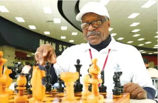  ?? David Woo photos/Dallas Morning News via AP ?? Donald Harris plays chess with Duncanvill­e High School student Pablo Ramirez (not pictured) on Dec. 11, 2017, during lunch. left