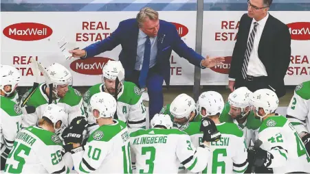  ?? JEFF VINNICK/GETTY IMAGES ?? Dallas Stars coach Rick Bowness, centre, says people don’t realize how difficult it is living in the bubble.