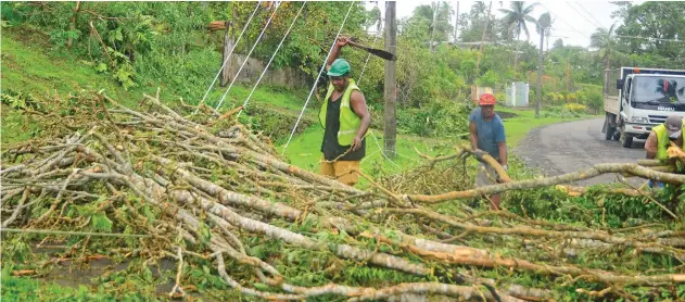  ??  ?? Workers clear debris from fallen power lines at Lami in February, 2016.