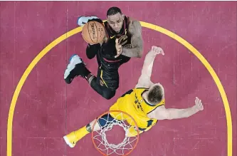  ?? TONY DEJAK THE ASSOCIATED PRESS ?? Cavaliers’ LeBron James, top, drives against Indiana Pacers’ Domantas Sabonis in the first half of Game 1 of their National Basketball Associatio­n first-round playoff series Sunday in Cleveland.