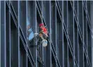  ?? Photo: Alex Plavevski/EPA-EFE ?? A window cleaner works on the façade of the Hopson Shanghai headquarte­rs building in Shanghai, China.