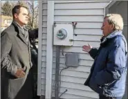  ?? MID-HUDSON NEWS NETWORK PHOTO ?? State Sen. David Carlucci, D-Nanuet, left, discusses a singed electric meter with a Rockland County resident.