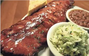  ?? STAN CARROLL/THE COMMERCIAL APPEAL ?? The rib plate with coleslaw and beans at Memphis Barbecue Co. on May 7, 2014.