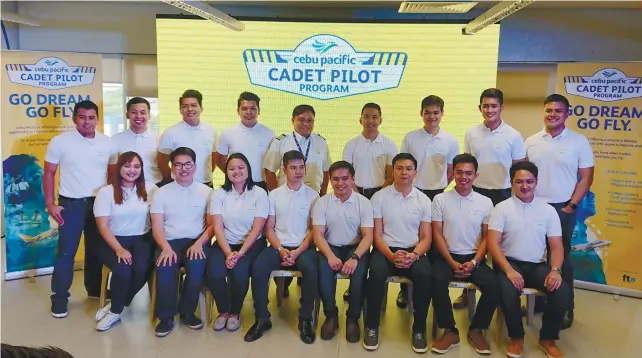  ?? SUNSTAR FOTO / MICHELLE P. SO ?? CADETS. These 16 young men and women are off to 52 weeks of flight training in Adelaide, Australia under the auspices of Cebu Pacific’s Cadet Pilot Program. With them is Capt. Paul Salvador (standing, fifth from left) of CebuGo and one of the spokes of the program. The other spoke is Capt. Samuel Avila (not in foto).