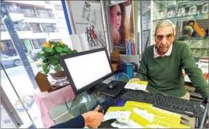  ?? MIGUEL ROJO/AFP ?? Uruguayan Enrique Curbelo sells marijuana at his pharmacy in Montevideo on July 9.