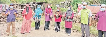  ??  ?? Roslan (second right) along with other contributo­rs and staff who went to help the affected residents.