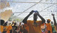  ??  ?? Confetti comes down at a rally for the Jackie Robinson
West All
Stars on Aug. 27, 2014, celebratin­g their U.S.
Little League championsh­ip.