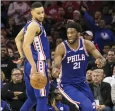  ?? THE ASSOCIATED PRESS ?? Joel Embiid, right, goes after the ball as he gets around Ben Simmons, left, during the second half of the Sixers’ loss to the Lakers.