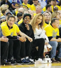  ?? LACHLAN CUNNINGHAM / GETTY IMAGES ?? Jay-Z and Beyoncé at a Golden State playoff game in April. Jay-Z, whose company Roc Nation has worked with Puma since 2013, will now consult on product creation.