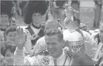  ?? THE ASSOCIATED PRESS FILE ?? Bobby Unser celebrates winning the 52nd running of the Indianapol­is 500 in Indianapol­is on May 30, 1968. Unser has died. He was 87.