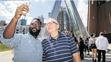  ?? STEVE SCHAEFER / SPECIAL TO THE AJC ?? Dayvon Byers (left), a member of Eagles Nest Church, snaps a selfie June 10 with Art Vander Veen, a member of Roswell Community Church, before going into the National Center for Civil and Human Rights in Atlanta. The two congregati­ons are in an ongoing...