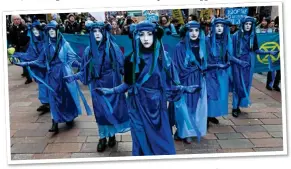  ??  ?? BLUE WAVE: Extinction Rebellion campaigner­s march in Glasgow yesterday