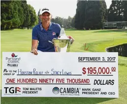  ?? — AP ?? Heart of gold: Stacy Lewis posing with the trophy and the mock cheque after winning the Portland Classic on Sunday. Lewis is donating her winnings to the Houston Relief to help the victims of Hurricane Harvey.