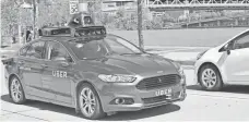  ?? UBER ?? Uber has been using a Ford Fusion Hybrid with a roof full of radar, lasers and cameras as its test model in Pittsburgh.