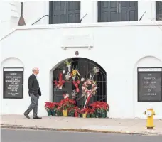  ?? LOGAN CYRUS, AFP/GETTY IMAGES ?? A man observes the memorial in front of Mother Emanuel AME Church in Charleston, S.C., on Wednesday, which marked the start of the sentencing phase for shooter Dylann Roof.