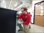  ?? ZACHARY SRNIS — THE MORNING JOURNAL ?? Luke Oliver, 17, a senior at the Lorain County JVS and Firelands High School, sets a network of switches and routers.