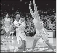  ?? NWA Democrat-Gazette/CHARLIE KAIJO ?? Arkansas guard Jaylen Barford drives to the basket against a Tennessee defender for two of his 28 points Saturday in the Razorbacks’ 95-93 overtime victory over the No. 19 Volunteers at Walton Arena in Fayettevil­le.