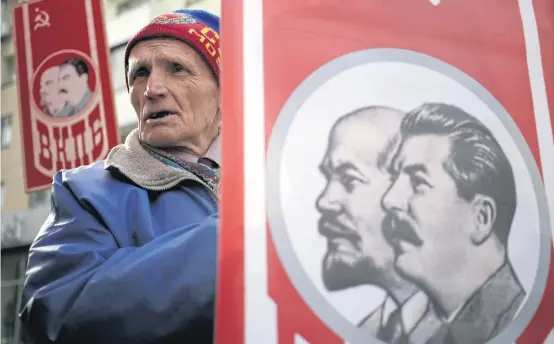  ?? AFP ?? A man holds a portrait of Lenin and Stalin at a rally to mark the 98th anniversar­y of Russia’s Bolshevik Revolution in Simferopol last month. Russia’s annexation of Crimea attests to the fact that geopolitic­s is back.