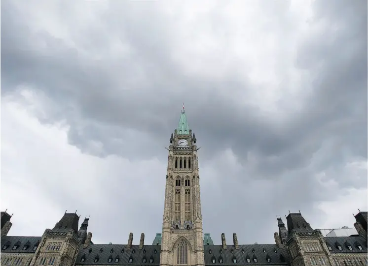  ?? ADRIAN WYLD / THE CANADIAN PRESS FILES ?? The sunny days economic document tabled by the federal Liberal government Wednesday doesn’t take into account dark clouds on the horizon, John Ivison notes.