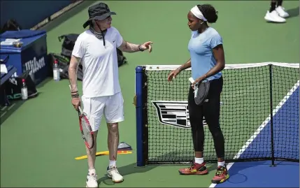  ?? EARL WILSON/NEW YORK TIMES ?? Tennis coach Brad Gilbert confers with Coco Gauff during a practice session Aug. 26 at the Billie Jean King National Tennis Center in New York. Now 62 and a decade removed from top-level coaching, Gilbert is back, albeit in a supporting role to the 19-year-old Gauff.