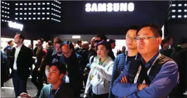  ?? JUSTIN SULLIVAN/GETTY IMAGES/AFP ?? Attendees watch a presentati­on at the Samsung booth during Consumer Electronic­s Show 2019 at the Las Vegas Convention Center on Wednesday in Las Vegas, USA.