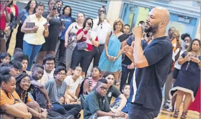  ?? [CHARLES SYKES/INVISION] ?? Musician and actor Common addresses the students and faculty Thursday at the Renaissanc­e School of the Arts in Harlem. Common encouraged the students to persevere — in school and in life.