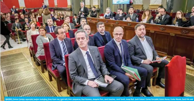  ??  ?? MADRID: Former Catalan separatist leaders including (from front row right-left) Oriol Junqueras, Raul Romeva, Joaquim Forn, Jordi Sanchez, Jordi Turull, Josep Rull, Jordi Cuixart, Carme Forcadell, Dolors Bassa, Carles Mundo, Santi Vila and Meritxel Borras attend their trial at the Supreme Court yesterday. — AFP