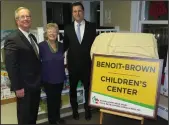  ?? Joseph B. Nadeau/The Call ?? From left, Douglas T. Brown, a longtime member of the Woonsocket Redevelopm­ent Agency; former state Rep. Nancy L. Benoit; and state Treasurer Seth Magaziner unveil the new sign for the Highland Park Children’s Center at 2390 Mendon Road, naming the...