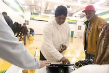  ?? Stephen Zenner/The Blade via AP ?? ■ Janice Baker, 64, and John Baker, 70, both of West Toledo check in to vote Tuesday at the Start High School Polling location in Toledo, Ohio.