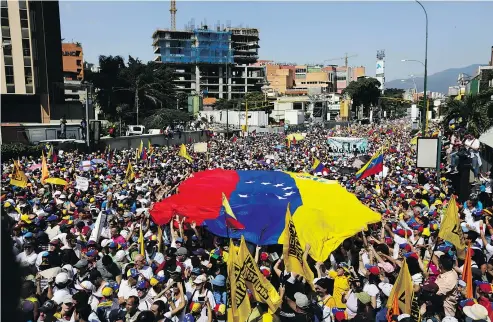  ?? — THE ASSOCIATED PRESS ?? Anti-government protesters gather in Caracas Saturday for the start of a nationwide demonstrat­ion demanding the resignatio­n of President Nicolas Maduro.