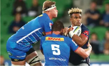  ?? DANIEL POCKETT EPA ?? WILL GENIA is well policed by Stormers players in Melbourne on Friday. |
